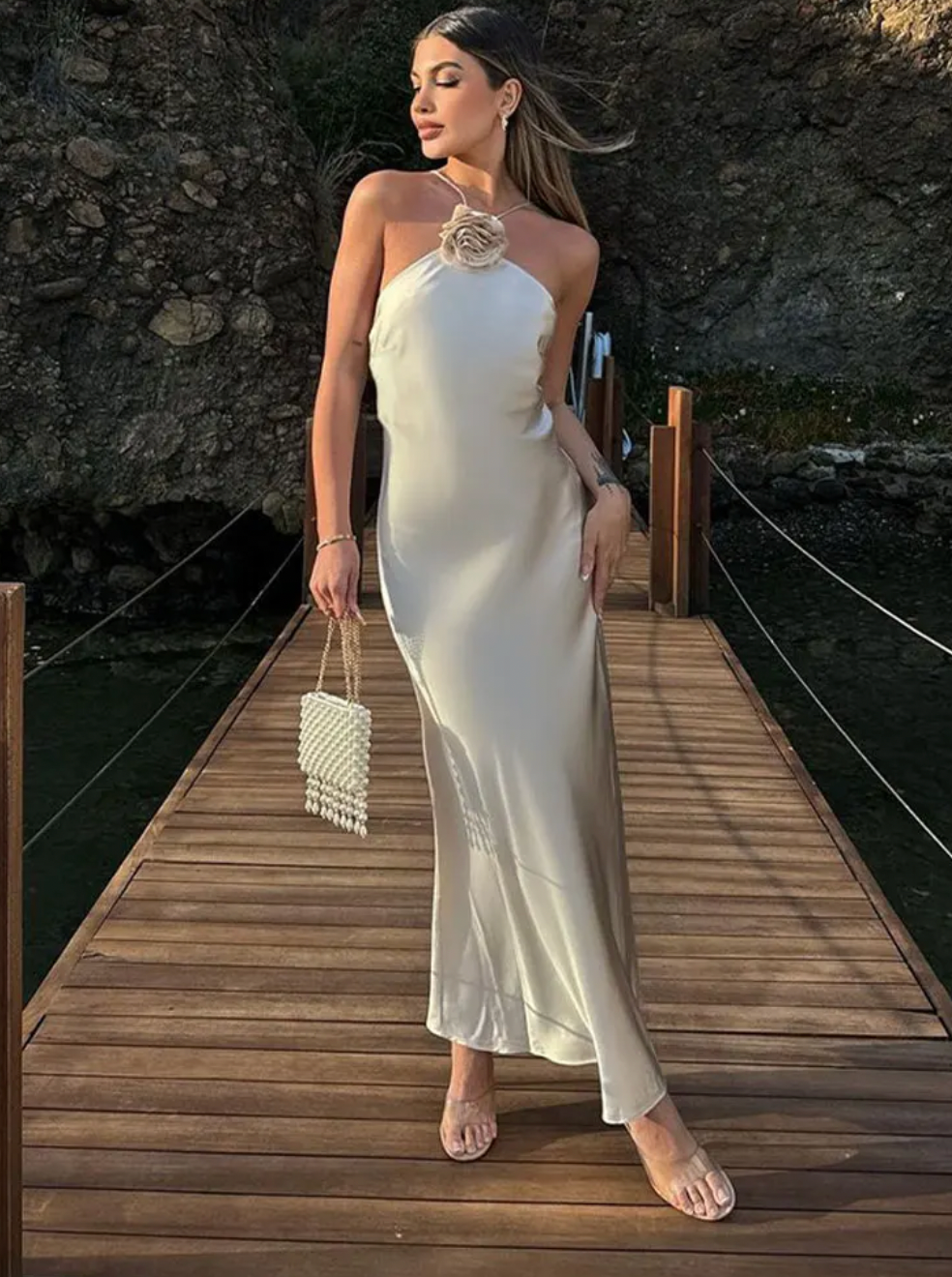 Introducing the Samantha Dress, a stunning addition to your wardrobe. Crafted from luxurious white satin, this elegant dress exudes sophistication and grace. Perfect for special occasions, it's the perfect choice for those looking to make a statement. Elevate your style with the Samantha Dress.