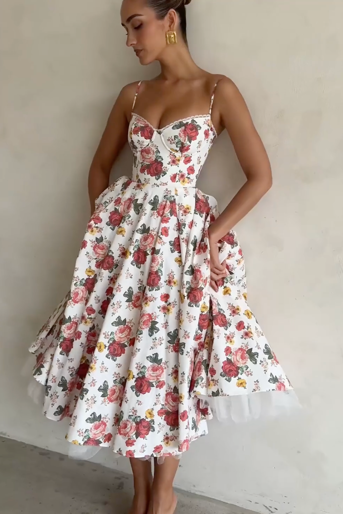 Indulge in the enchanting beauty of the Italian Rose Midi Dress. With a boned bodice, sweetheart neckline, and delicate adjustable straps, this dress cinches your waist and flatters your figure. The floaty midi skirt, featuring a voluminous layer of soft tulle, exudes an elegant and ethereal charm.