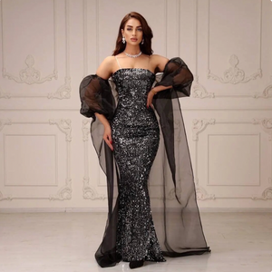 Indulge in the luxurious style of our Dress Nadine. This strapless gown features intricate sequin detailing in a mermaid silhouette, crafted from high-quality tulle for a striking and elegant look. Perfect for proms, evening events, or cocktail parties, this floor-length dress will elevate your style to new heights.