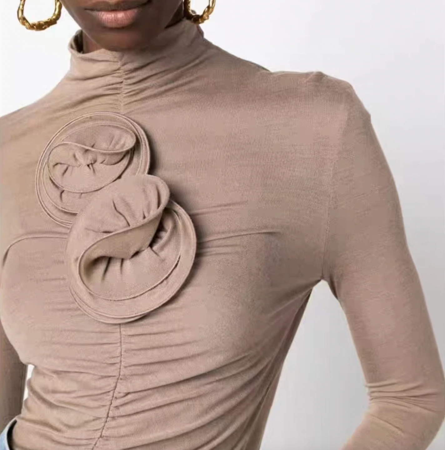 Indulge in the opulent elegance of this ruched floral-appliqué turtleneck top. Handcrafted with exquisite three-dimensional floral appliqués and pleated knit fabric, this high neck top exudes sophistication and luxury. Perfect for adding a touch of artistic flair to any outfit, plus enjoy free shipping with your purchase.