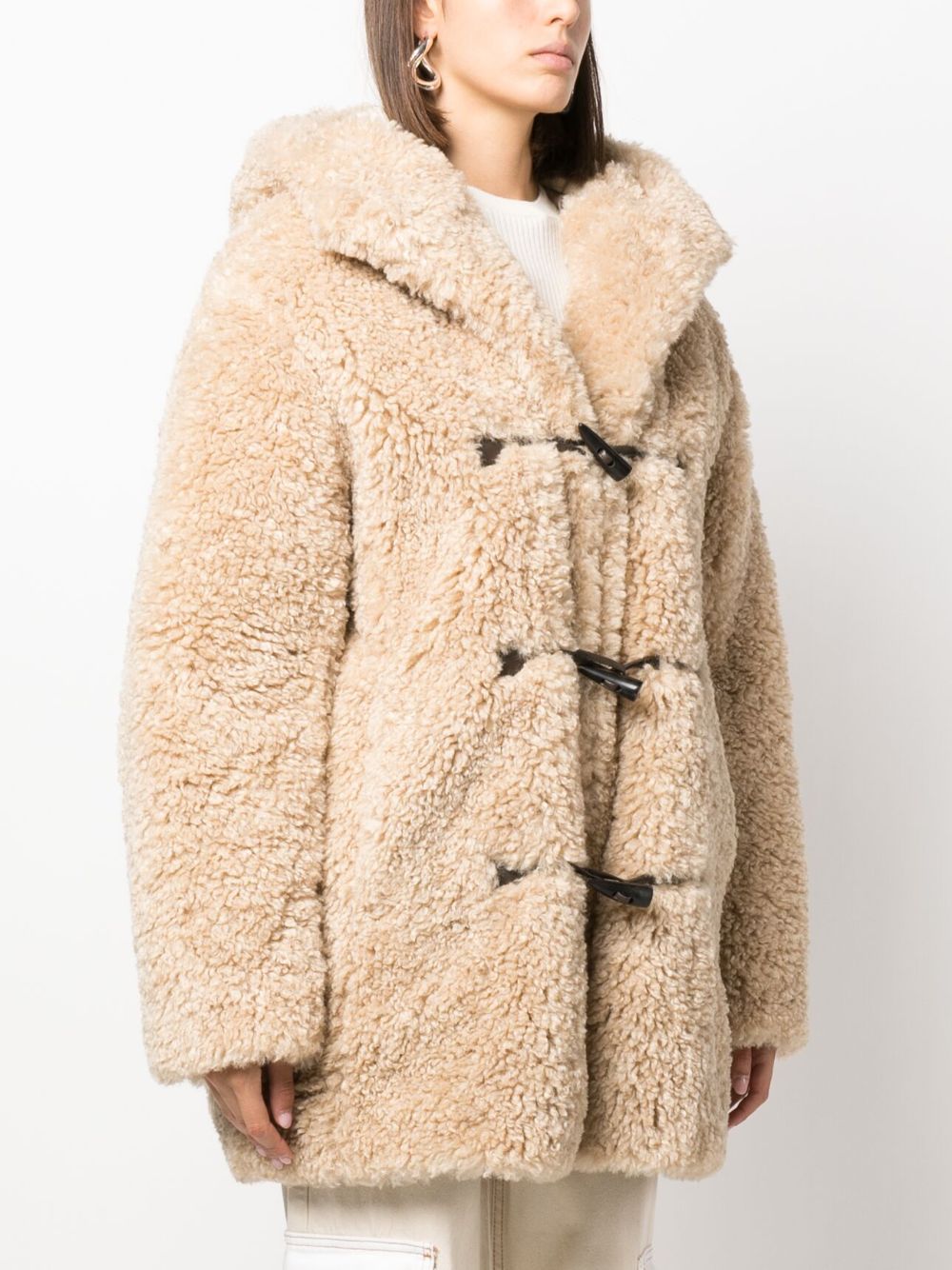 Introducing the must-have Faux-fur Hooded Coat by Marant Étoile. Crafted with a soft faux-fur exterior, this coat combines luxury and comfort. The classic hood and front toggle fastening add a timeless touch to the piece. With its beige hue and functional side pockets, it's a practical and stylish addition to any wardrobe. Worn by Emily in Paris.