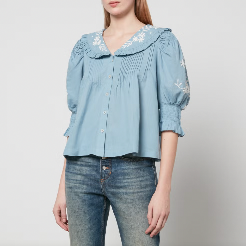 Introducing the Kyla Top from Sea New York - a blend of vintage and modern styles. Made from linen and cotton, this top boasts lace embellishment and floral embroidery, pairing beautifully with the Peter Pan collar for a romantic and airy look. Perfect with trousers and mules.