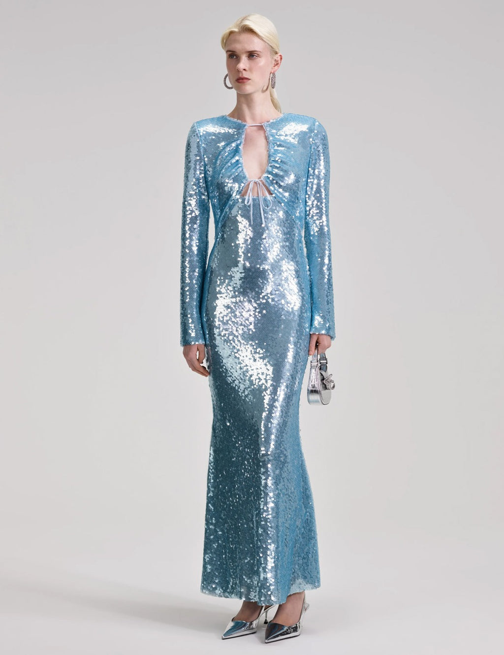 Indulge in glamour and shine with Self-Portrait's Sequin Maxi Dress. Crafted from a comfy woven fabric, this dress flatters with a shapely, slim fit and is adorned with sparkling sequins. Perfect for balls or disco nights, the dress creates a mesmerizing mirror ball effect. Let your inner diva shine!