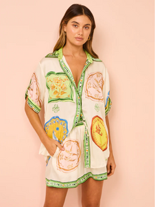 The Paradiso Porcelain Silk Set is perfect for those dreaming of a tropical escape. Crafted from luxurious silk satin, this set includes a shirt with a point collar, rolled sleeves, and shell buttons, and matching shorts or pants. Add a relaxed touch to your beach to bar look with its stunning print.