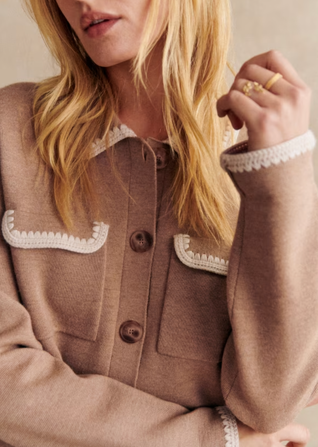 Expertly crafted from soft merino wool, the Betty Cardigan is perfect for cooler days. With a classic shirt collar and pockets on the chest, this short cardigan is finished with delicate crochet details on the collar, pockets, and cuffs. Elevate your wardrobe with this timeless and versatile piece.