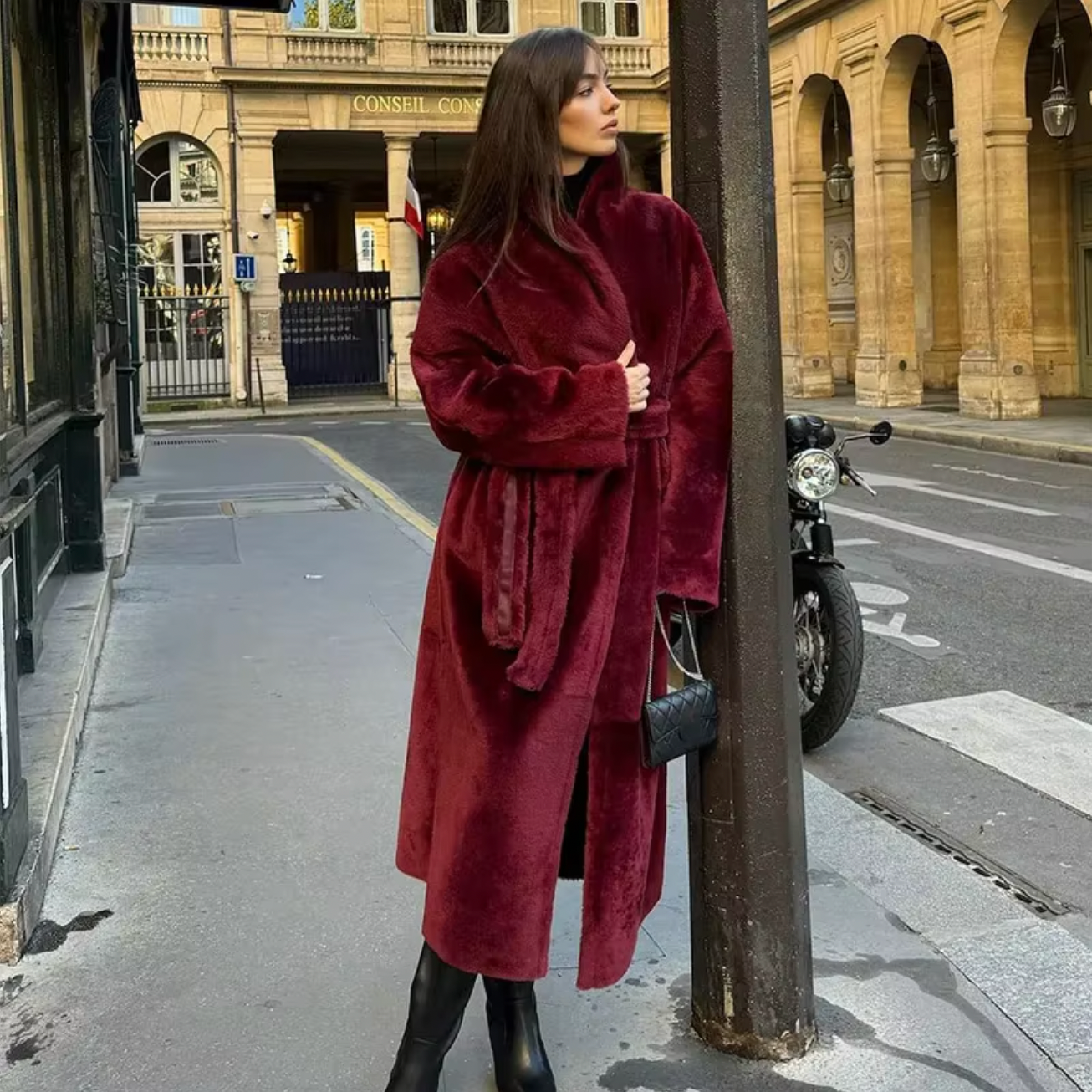 Stay warm and stylish with the Ana Shearling Coat! This women's overcoat features double-sided fur and premium leather for a luxurious touch. The chic burgundy color, elegant lapel, and lace-up details add a touch of glamour to your winter wardrobe. The adjustable belt provides a flattering fit while keeping you cozy. (Winter just got a lot more chic!)