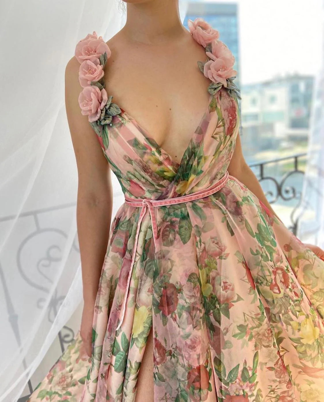 Experience the beauty of a flower field with our Dreamy Scarlet Gown. Made from printed organza, this gown features delicate handmade embroidered blooms along the shoulder straps. A luxurious velvet belt defines the waist, creating a flattering silhouette. Let this gown transport you to a dreamy garden, wherever you may go.