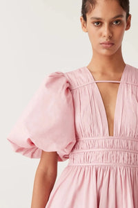 Elevate your special occasion look with the Fallingwater Ruched Midi Dress by AJE. Made from sweet 'Chalk Pink' cotton-poplin, this dress boasts a romantic and playful silhouette with voluminous puffed sleeves and a cinched waist. Rent now to make a stand-out statement!