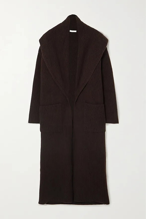 Indulge in luxury and sophistication with the Daelan Oversized Ribbed Wool Coat from The Row. Crafted in Italy from 100% wool, the dark brown longline design features bold shawl lapels and patch pockets, making it a must-have statement piece for the fashion-forward individual. Elevate your style and stand out from the crowd.