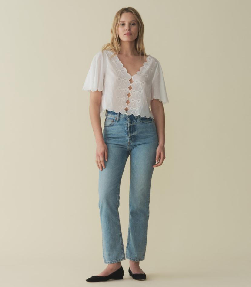 The Kacy Top by DOEN blends vintage charm with modern elegance. Crafted in 100% organic cotton voile, this blouse features charming cutouts, delicate bow embroidery, and breezy elbow-length sleeves. With scalloped details and delicate dot embroidery, this top is a playful yet sophisticated addition to your wardrobe.