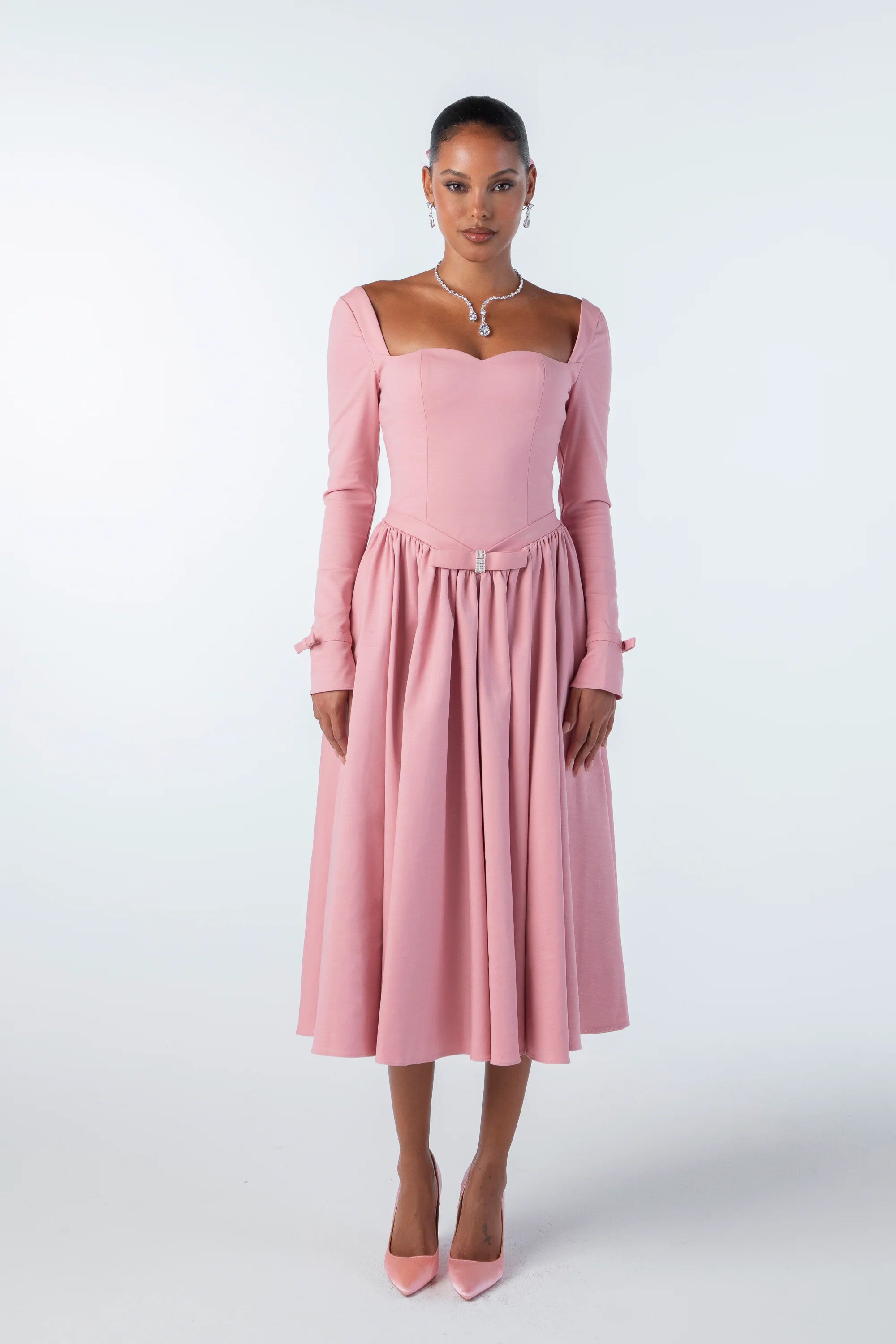 The Bernadette Midi Dress effortlessly combines sophistication and grace with its sweetheart neckline and oversized umbrella skirt. The neckline accentuates elegance, while the skirt adds movement, creating a captivating silhouette. Elevate your wardrobe with this elegant and exclusive piece.