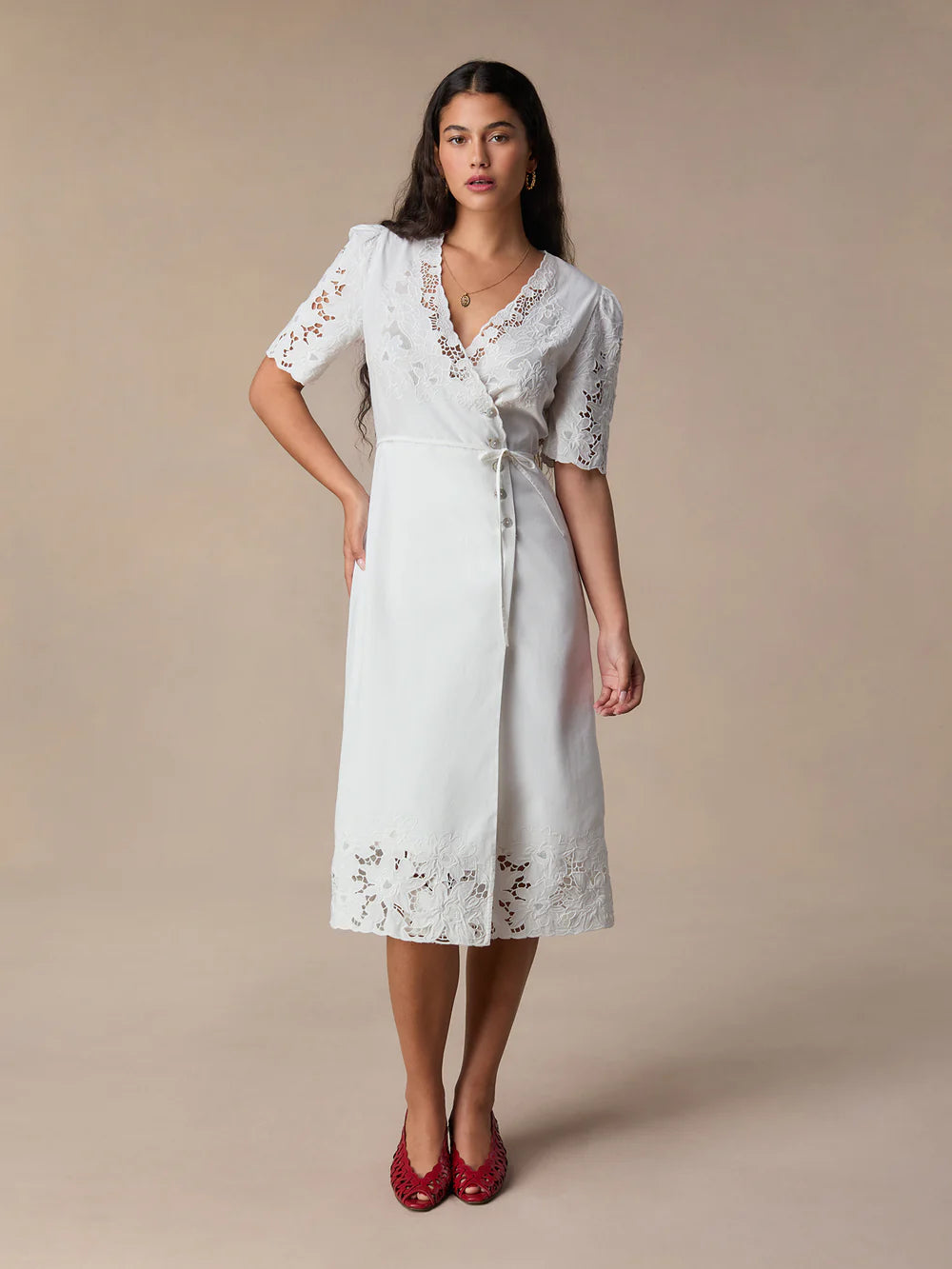 This stunning Audrey Midi Dress is perfect for any occasion. The elegant white embroidery adds a touch of sophistication, while the mid-length and wrap design create a flattering and versatile silhouette. Dress it up or down, this dress is sure to make you feel confident and chic!