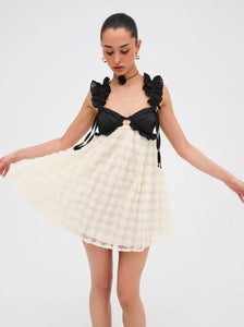 The Poppy Mini dress by For Love & Lemons is both pretty and practical, with 3D rose flock dot fabric, contrast satin cups, and supportive underwire. The chiffon ruffled straps and sheer skirt add a touch of elegance, while the keyhole at the back and invisible zip closure make it easy to wear. Fully lined for comfort.