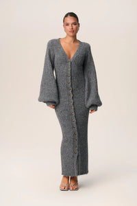 Embrace luxury with the Silana Knit Dress. This maxi dress in grey melange is made from a cozy wool-blended fabric for both style and warmth. Boasting an hourglass fit, front button-up closure, and elegant V-neck collar, this dress exudes sophistication. Complete with full-length balloon sleeves and distinctive cuffs, elevate your style with this exclusive piece.