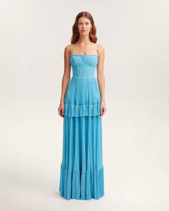 Indulge in elegance with the Eden Maxi Dress. The sky-blue mesh fabric creates a graceful silhouette with a structured boned bustier bodice, adorned with delicate spaghetti straps. The pleated A-line maxi skirt adds a touch of sophistication to your every step. Perfect for any special occasion.