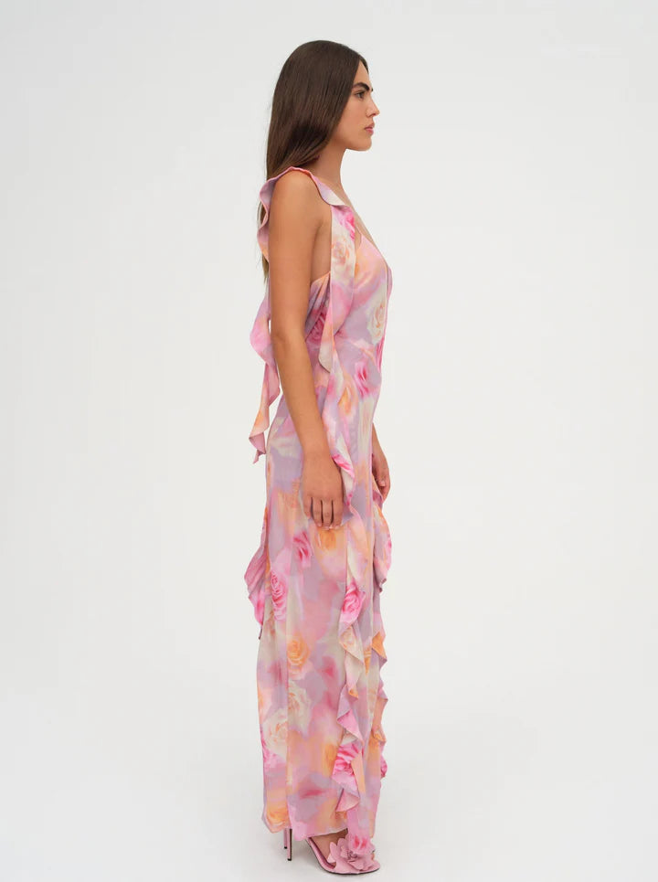 Unleash your inner romantic with the Beate Maxi Dress. With a dreamy rose print and cascading ruffles, this pink asymmetrical dress exudes charm and elegance. The removable shoulder ruffle and thigh-high slit add a touch of playfulness.