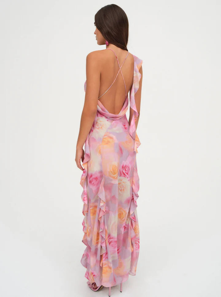 Unleash your inner romantic with the Beate Maxi Dress. With a dreamy rose print and cascading ruffles, this pink asymmetrical dress exudes charm and elegance. The removable shoulder ruffle and thigh-high slit add a touch of playfulness.