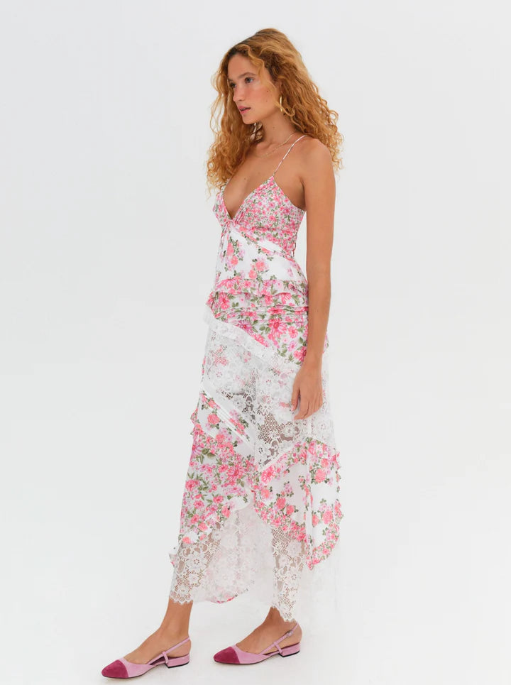 Introducing the luxurious Rosalyn Dress from For Love and Lemons, back in a stunning blue floral print. Inspired by '70s fashion, this maxi dress features mixed print paneling and delicate floral lace with elegant ruffle details. The plunging neckline and skinny shoulder ties add a touch of sophistication. Perfectly fitted through the bust, this dress then cascades into an A-line silhouette, creating a flattering and effortless look. 