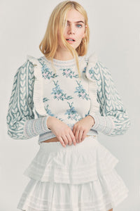 Elevate your style with Warwick in Dew Drop Cream. The romantic floral knit intarsia and framing knit heart jacquard blouson sleeves add a touch of elegance to this cropped crewneck sweater. The striped rib knit neck, cuffs and hem offer a flattering fit and extra detail. Embrace your feminine side with this must-have sweater.