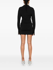 Expertly designed in Italy, The Attico Cut-out Mini Dress is the perfect addition to any fashionable wardrobe. The stretch-design allows for comfortable all-day wear, while the draped and gathered detailing adds a touch of elegance. Complete with a logo print, pointed collar, and concealed button fastening, this above-knee length dress is a must-have for any stylish occasion. Please note, as this piece is handmade, each purchase is unique and may vary slightly from the item pictured.