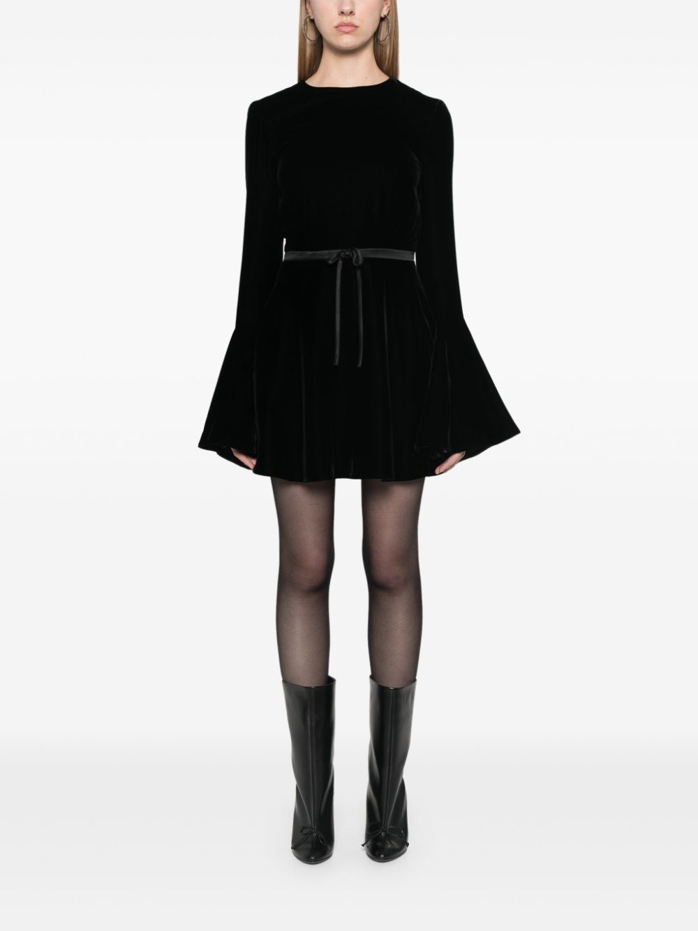 Indulge in opulence with SAINT LAURENT's velour mini dress. The retro-inspired bell sleeves and flared skirt exude a skater vibe, while the open back adds a touch of sensuality. Made in Italy, the plush velour is elevated by a satin belt that cinches your waist. Complete the look with stilettos and a mini bag.