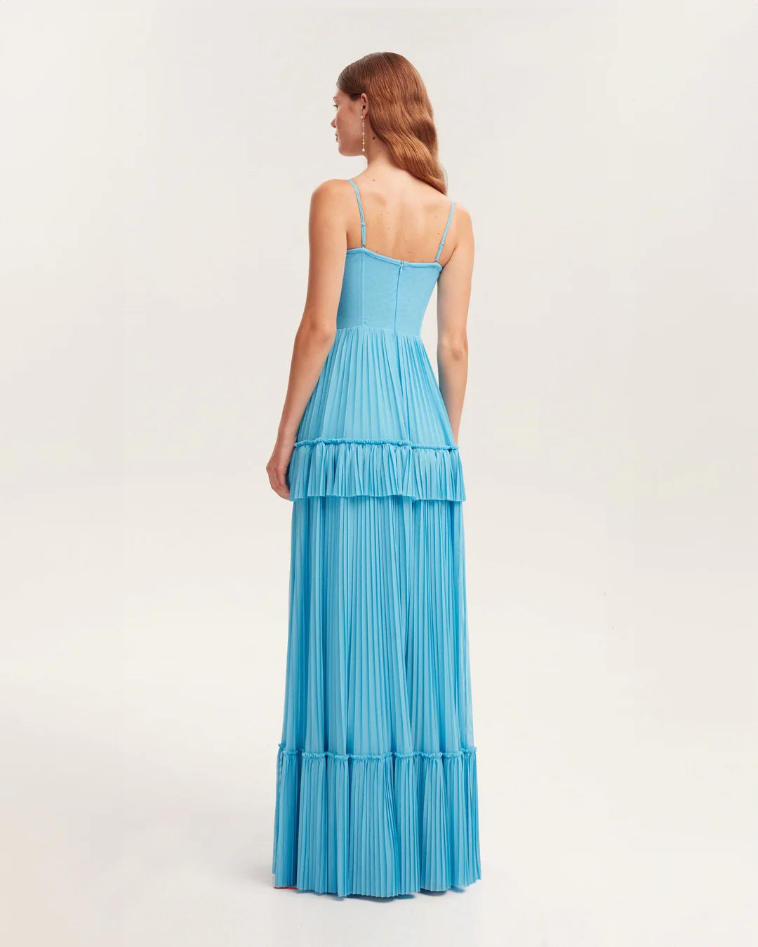 Indulge in elegance with the Eden Maxi Dress. The sky-blue mesh fabric creates a graceful silhouette with a structured boned bustier bodice, adorned with delicate spaghetti straps. The pleated A-line maxi skirt adds a touch of sophistication to your every step. Perfect for any special occasion.