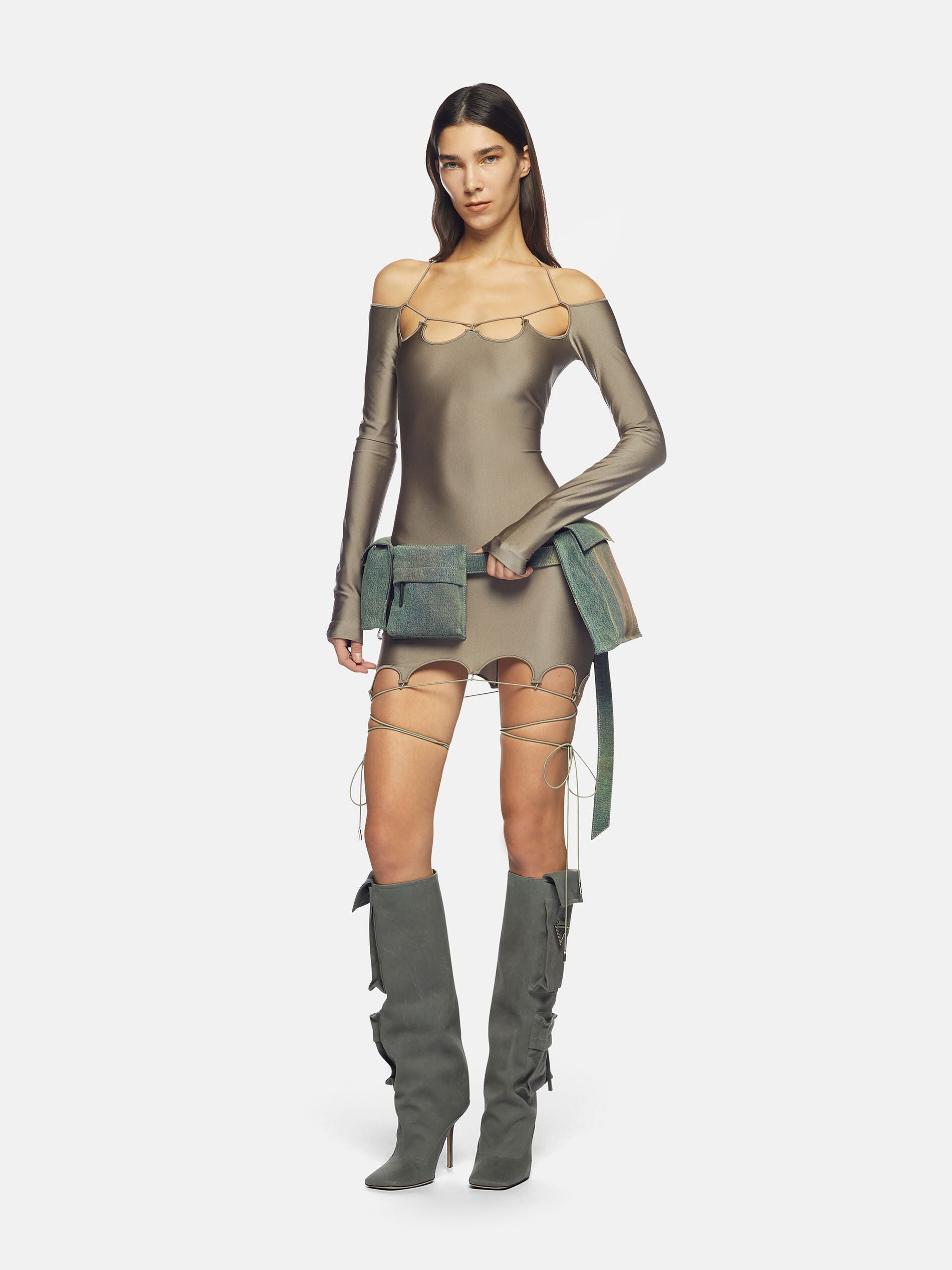 The "Lyna" military-inspired mini dress showcases a scalloped neckline and hem in glossy lycra, while also including signature cylindrical logo metal accents. With a sleek and refined appearance, this dress is suitable for any event and is guaranteed to make a bold impression, courtesy of The Attico.