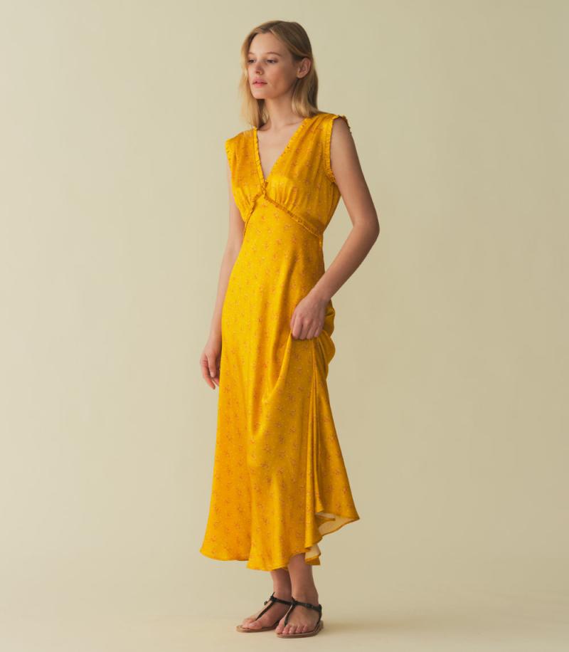 Indulge in luxury with the Tahlia Dress. Made from stunning silk-satin, this ‘30s-inspired dress exudes elegance with its plunging V-neckline, surplice back, and delicate ruffle trim. The adjustable back waist tie ensures a perfect fit, while the snap closure adds a touch of versatility. Perfect for any occasion.