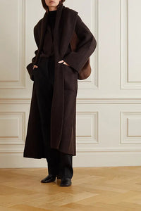 Indulge in luxury and sophistication with the Daelan Oversized Ribbed Wool Coat from The Row. Crafted in Italy from 100% wool, the dark brown longline design features bold shawl lapels and patch pockets, making it a must-have statement piece for the fashion-forward individual. Elevate your style and stand out from the crowd.