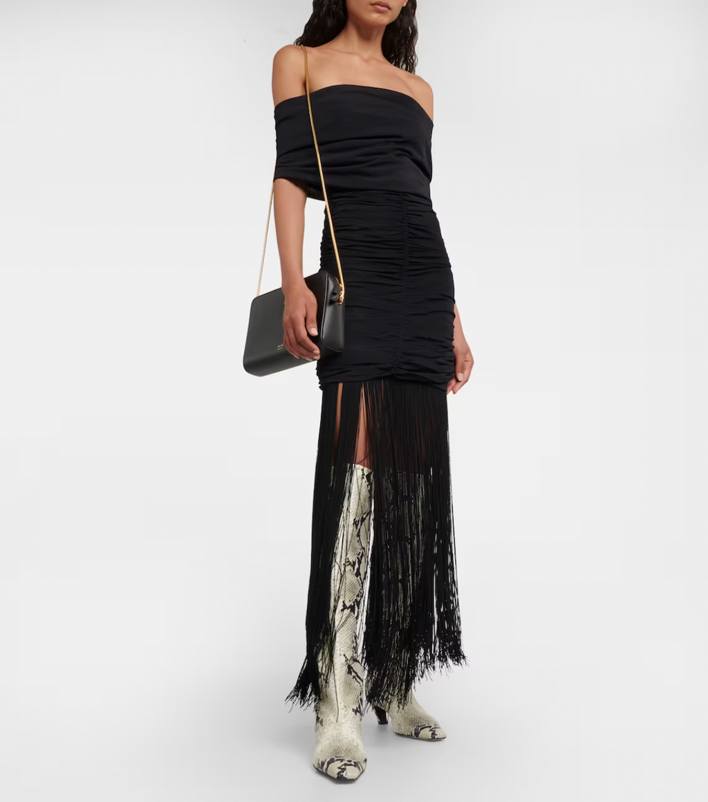 Introducing the Jacinta Maxi Dress by Khaite - a fusion of elegance and modernity. This luxurious slip-on dress boasts an off-shoulder neckline, adorned with long fringes and full ruching for a flattering silhouette. Perfect for any special occasion, elevate your style with this sophisticated must-have.