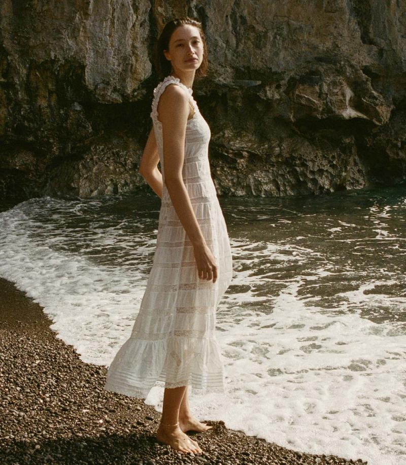 Indulge in luxury with the DÔEN Angeletta Dress. Crafted from 100% organic cotton voile, this dress exudes elegance with its delicate lace panels and petite trims. An invisible side zipper and A-line skirt provide a perfect fit, making it a sophisticated and exclusive treasure.