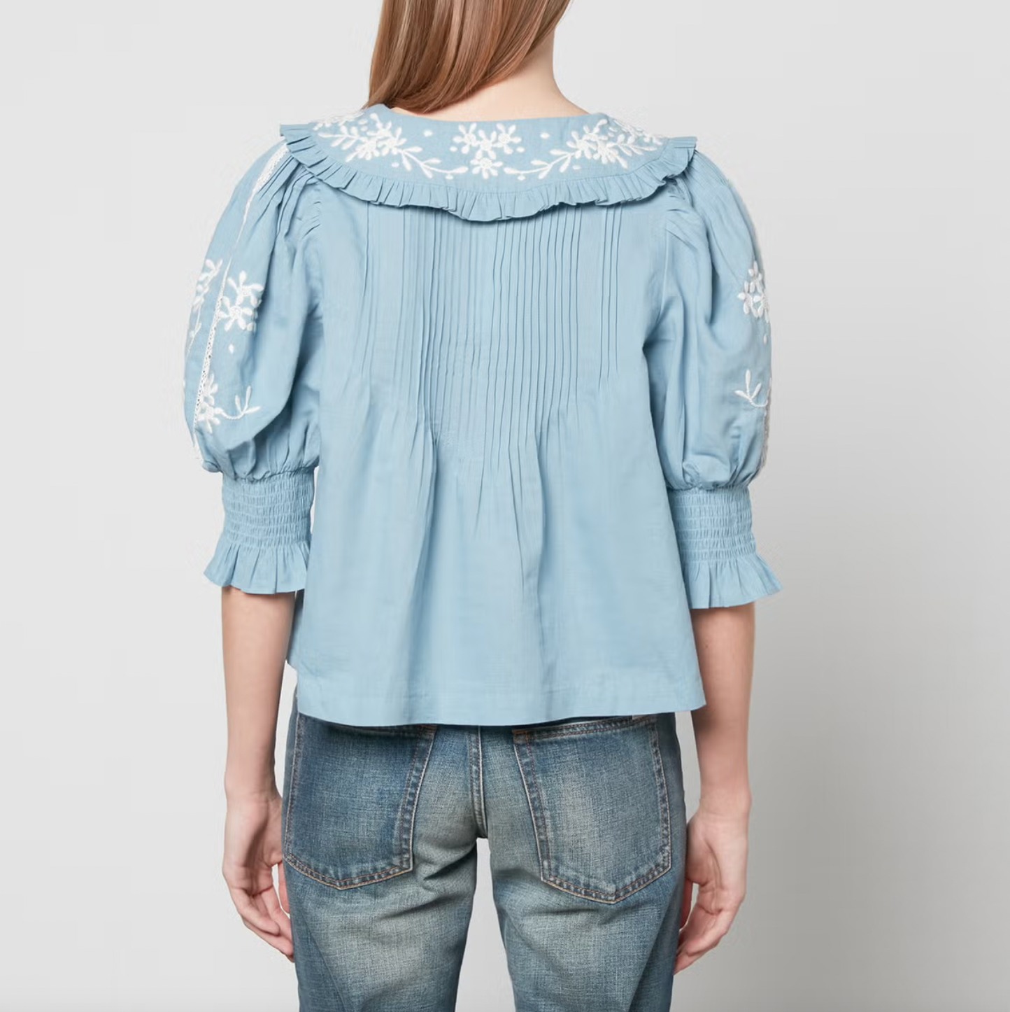 Introducing the Kyla Top from Sea New York - a blend of vintage and modern styles. Made from linen and cotton, this top boasts lace embellishment and floral embroidery, pairing beautifully with the Peter Pan collar for a romantic and airy look. Perfect with trousers and mules.