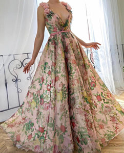 Experience the beauty of a flower field with our Dreamy Scarlet Gown. Made from printed organza, this gown features delicate handmade embroidered blooms along the shoulder straps. A luxurious velvet belt defines the waist, creating a flattering silhouette. Let this gown transport you to a dreamy garden, wherever you may go.