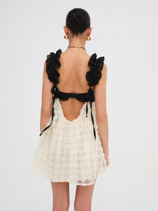 The Poppy Mini dress by For Love & Lemons is both pretty and practical, with 3D rose flock dot fabric, contrast satin cups, and supportive underwire. The chiffon ruffled straps and sheer skirt add a touch of elegance, while the keyhole at the back and invisible zip closure make it easy to wear. Fully lined for comfort.