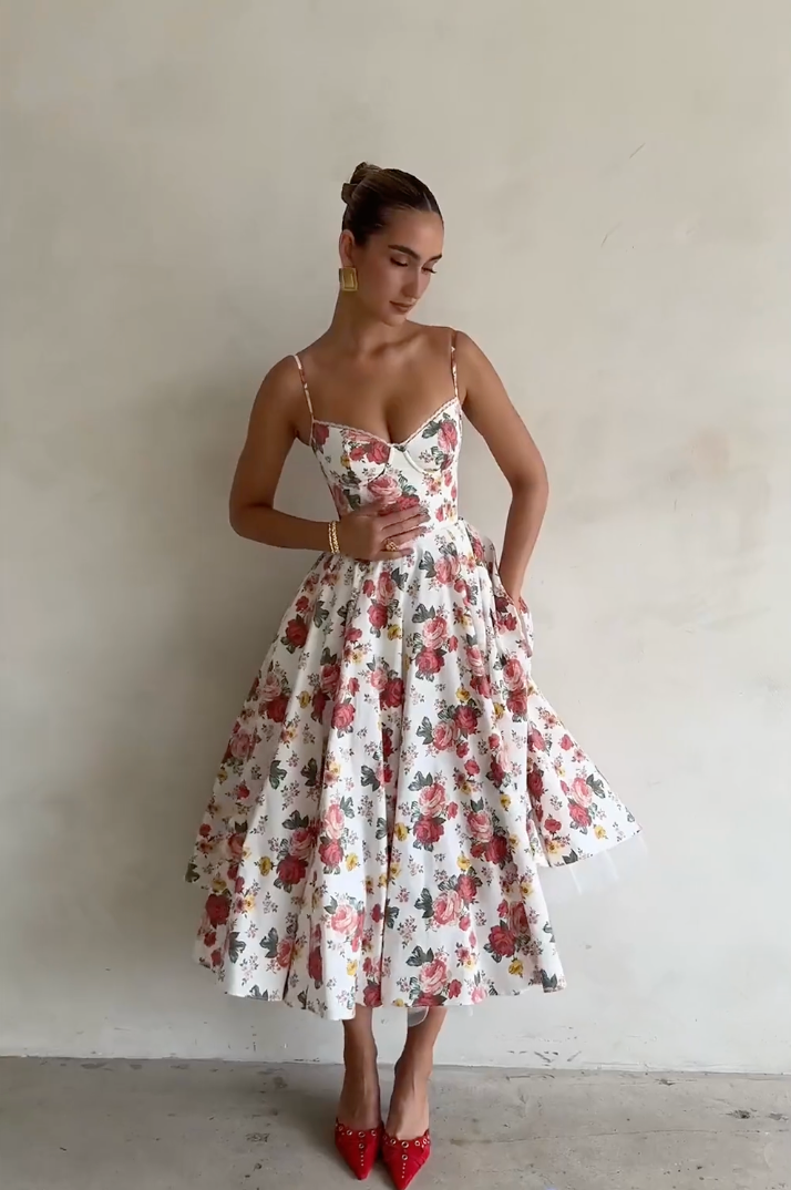 Indulge in the enchanting beauty of the Italian Rose Midi Dress. With a boned bodice, sweetheart neckline, and delicate adjustable straps, this dress cinches your waist and flatters your figure. The floaty midi skirt, featuring a voluminous layer of soft tulle, exudes an elegant and ethereal charm.