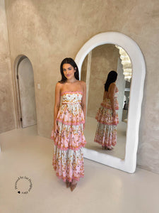 Get ready to turn heads in the Laurel Frill Maxi Dress! Perfect for weddings, baby showers, and garden events, this dress is both feminine and fun. You'll love the straight neckline with scallop cut detail, tiered frill skirt, and open back. Plus, the lace up corset allows for a comfortable fit on any body shape.