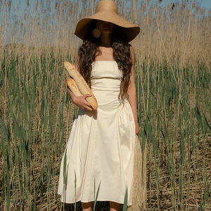 Introducing our Lily Dress, crafted with soft, breathable cotton for ultimate comfort. This strapless dress boasts a fitted bodice that accentuates your figure and transitions into a gathered hip, mid-length skirt. Its bold minimalist design highlights your natural curves, making it the perfect choice for dreamy summer days.