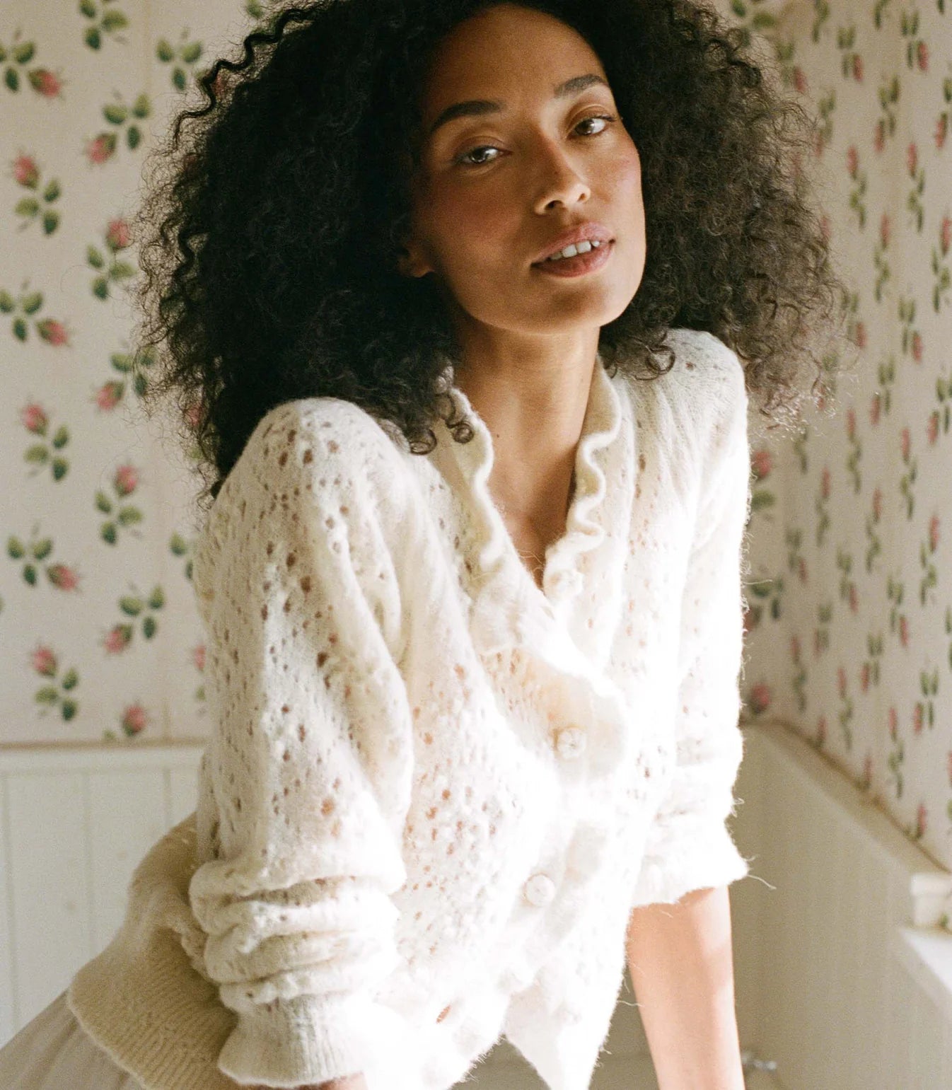 Elevate your wardrobe with the vintage-inspired Claudie Cardigan by Doen. Expertly crafted in a soft baby alpaca blend, this cardigan features a delicate pointelle design and elegant ruffles. The high neck and fitted silhouette add a touch of sophistication, while the floral crochet-covered buttons add a charming detail. Perfect for any occasion, this cardigan is a must-have for any fashion enthusiast.