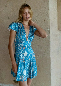 The Dianne Dress in buttery sandwashed silk satin combines elegance and playfulness. Featuring a deep V-neckline and cap sleeves with embroidered scallop detailing, it is designed to highlight the silhouette with a fitted bodice and an adjustable waist tie. Completed with an A-line skirt and a playful mini hemline, this dress is perfect for both casual outings and special occasions.