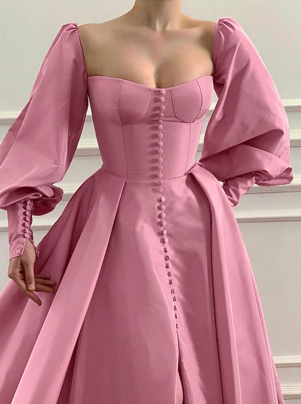 Evoke fairy tale fantasies in our Robe Eloise. The rose pink taffeta gown creates a flattering A-line silhouette with a structured bodice and lace-up back, while the gathered skirt and train exude elegance and sophistication. Complete the enchanting look with our specially designed embroidered ruffle heart gloves. Perfect for balls, weddings, and grand occasions.