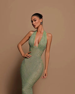 Introducing the Zinnia Sparkling Gown, a true showstopper. Embellished with delicate beads, this gown exudes luxury and sophistication. The halter neck adds a touch of elegance, while the sheer lining creates a sense of allure. Perfect for formal events or special occasions, feel like a true queen in the Zinnia Gown.