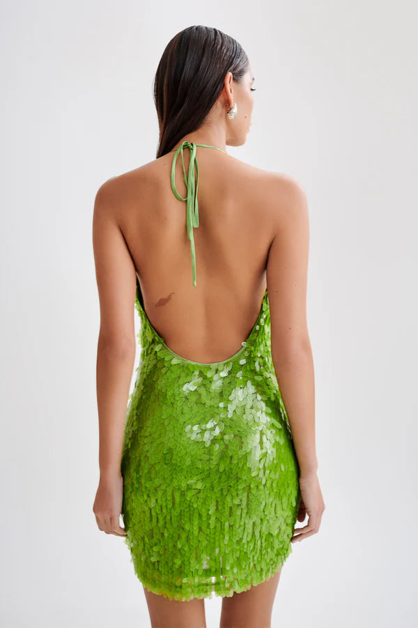 Make a statement with the dazzling Sequin Halter Mini Dress. The plunging halter neckline and shimmering sequins will turn heads at any party or special event. The fitted silhouette and mini length accentuate your curves, while the vibrant parakeet green color adds a touch of glamour. Elevate your wardrobe with this must-have dress that exudes sophistication and elegance.