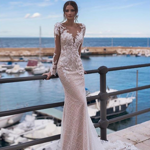 Attain elegance and timeless beauty with Robe Ethel! This unique mermaid gown features alluring lace appliques and sparkling ivory bridal gown details, making it the perfect choice for any bride looking to add a touch of glamour to her special night!