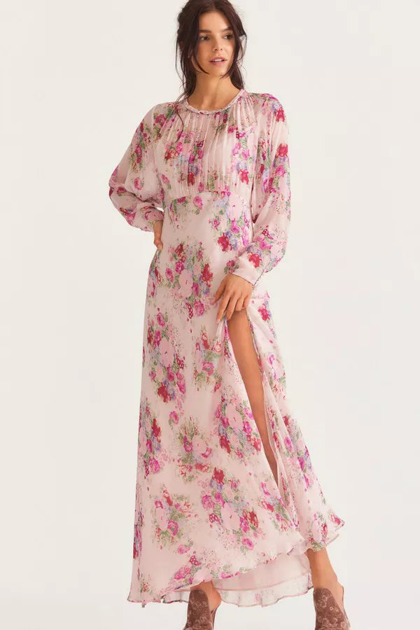 Elevate your style with the luxurious Daya Maxi Dress by LoveShackFancy. With a stunning French floral print, hand smocking, and a roping detail inspired by the 1920s, this viscose dress exudes elegance. The relaxed bodice and slim fitted skirt with a flirty slit create a sophisticated silhouette. Lined with a back slit and fastened with self-loop buttons, it pairs perfectly with sunglasses for a chic look.