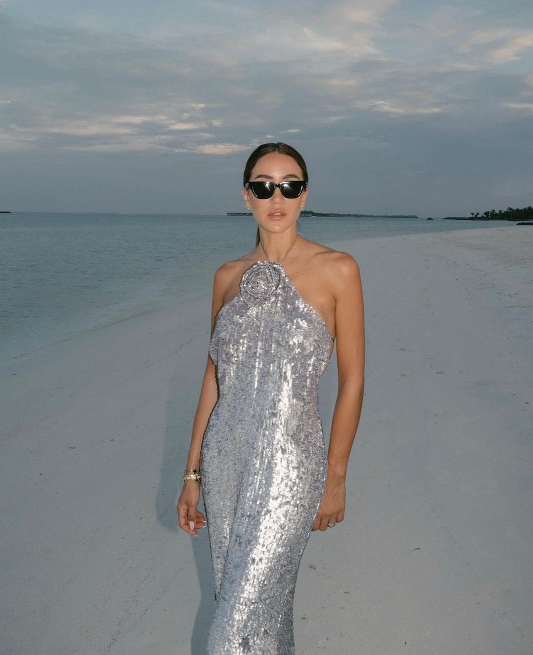 Looking to make a statement? The Magda Butrym Sequin Maxi Dress in Silver is a must-have item for your wardrobe. Its lightweight yet structured fabric creates a beautiful silhouette, while the soft and feminine color adds a touch of elegance. Perfect for any special occasion, this dress will be a timeless staple in your closet.