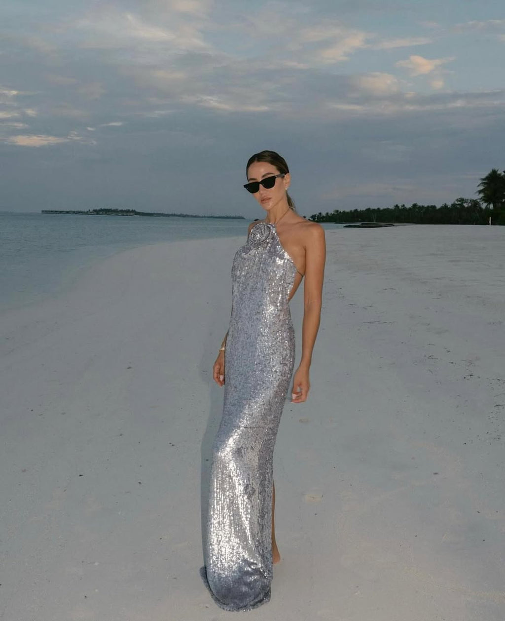 Looking to make a statement? The Magda Butrym Sequin Maxi Dress in Silver is a must-have item for your wardrobe. Its lightweight yet structured fabric creates a beautiful silhouette, while the soft and feminine color adds a touch of elegance. Perfect for any special occasion, this dress will be a timeless staple in your closet.