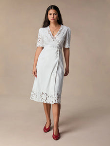 This stunning Audrey Midi Dress is perfect for any occasion. The elegant white embroidery adds a touch of sophistication, while the mid-length and wrap design create a flattering and versatile silhouette. Dress it up or down, this dress is sure to make you feel confident and chic!