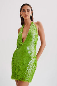 Make a statement with the dazzling Sequin Halter Mini Dress. The plunging halter neckline and shimmering sequins will turn heads at any party or special event. The fitted silhouette and mini length accentuate your curves, while the vibrant parakeet green color adds a touch of glamour. Elevate your wardrobe with this must-have dress that exudes sophistication and elegance.