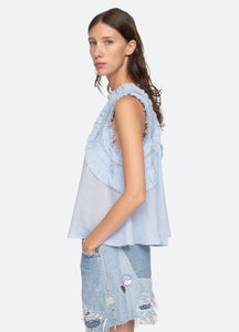 Elevate your wardrobe with the Cole Tank by Sea New York. This sleeveless tank features delicate smocked detailing and ruffle accents, giving it a romantic and feminine feel. The flutter sleeves add a touch of whimsy to this elegant top, making it the perfect addition to your collection. Designed for an effortless yet refined look.