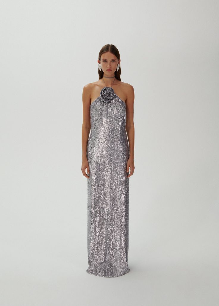 Looking to make a statement? The Magda Butrym Sequin Maxi Dress in Silver is a must-have item for your wardrobe. Its lightweight yet structured fabric creates a beautiful silhouette, while the soft and feminine color adds a touch of elegance. Perfect for any special occasion, this dress will be a timeless staple in your closet.